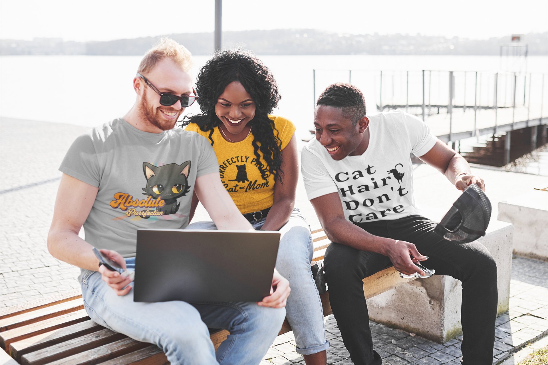 Three friends wearing Buckeye Brushworks designs — Absolute Purrfection, Cat Mom, and Cat Hair Don't Care tees